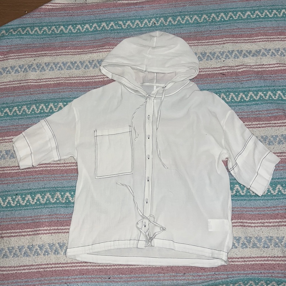White short-sleeved hooded blouse with black contrast stitching